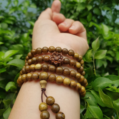 Vòng đeo tay nữ gỗ trầm mix bông hoa sen kiểu quấn tay 4 vòng may mắn tài lộc  Size hạt 6mm  Màu vàng nâu vân sáng nhẹ đeo tay rất đẹp xinh mùi thơm nhẹ nhẹ ạ